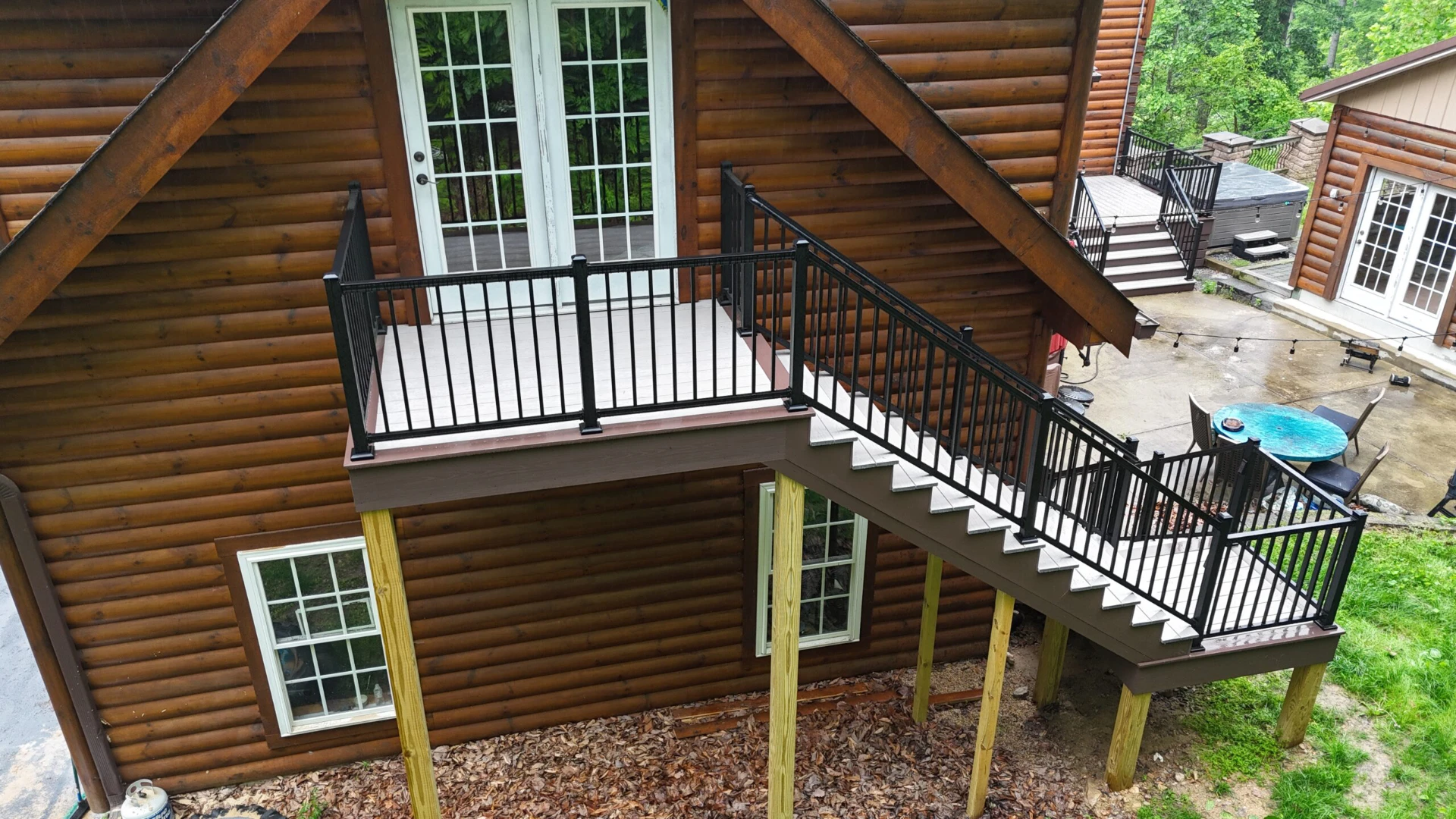 3d design of long stairs with black metal railing and a white door with a glass