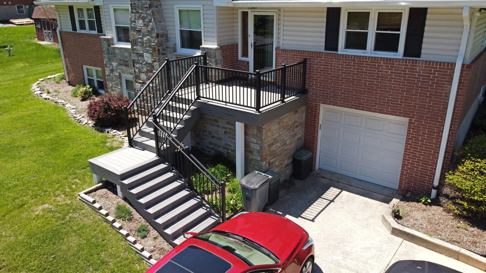 Aerial view of carports with residential deck and black deck railing
