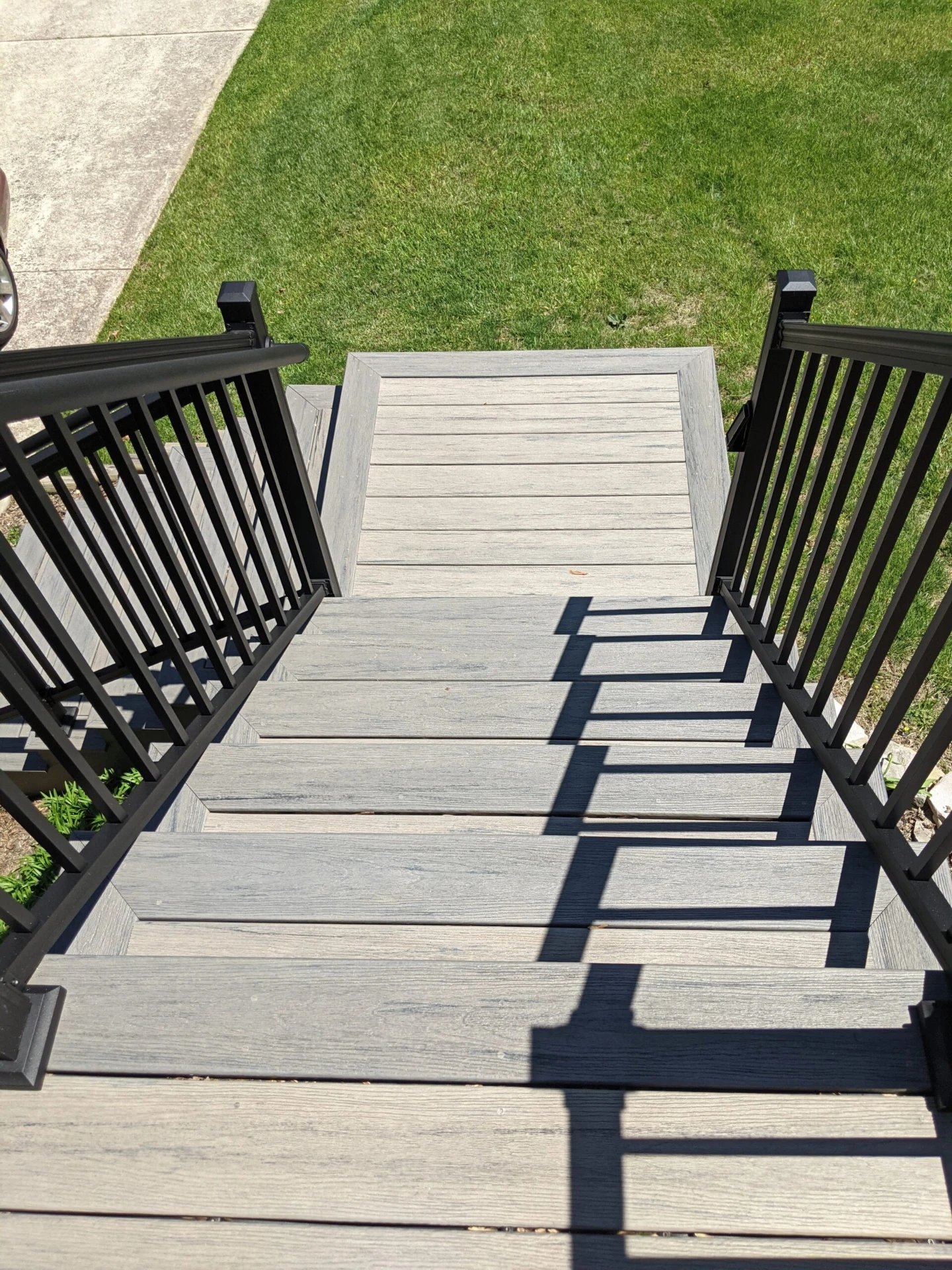 Aerial view of the wood stairs and black metal deck railing