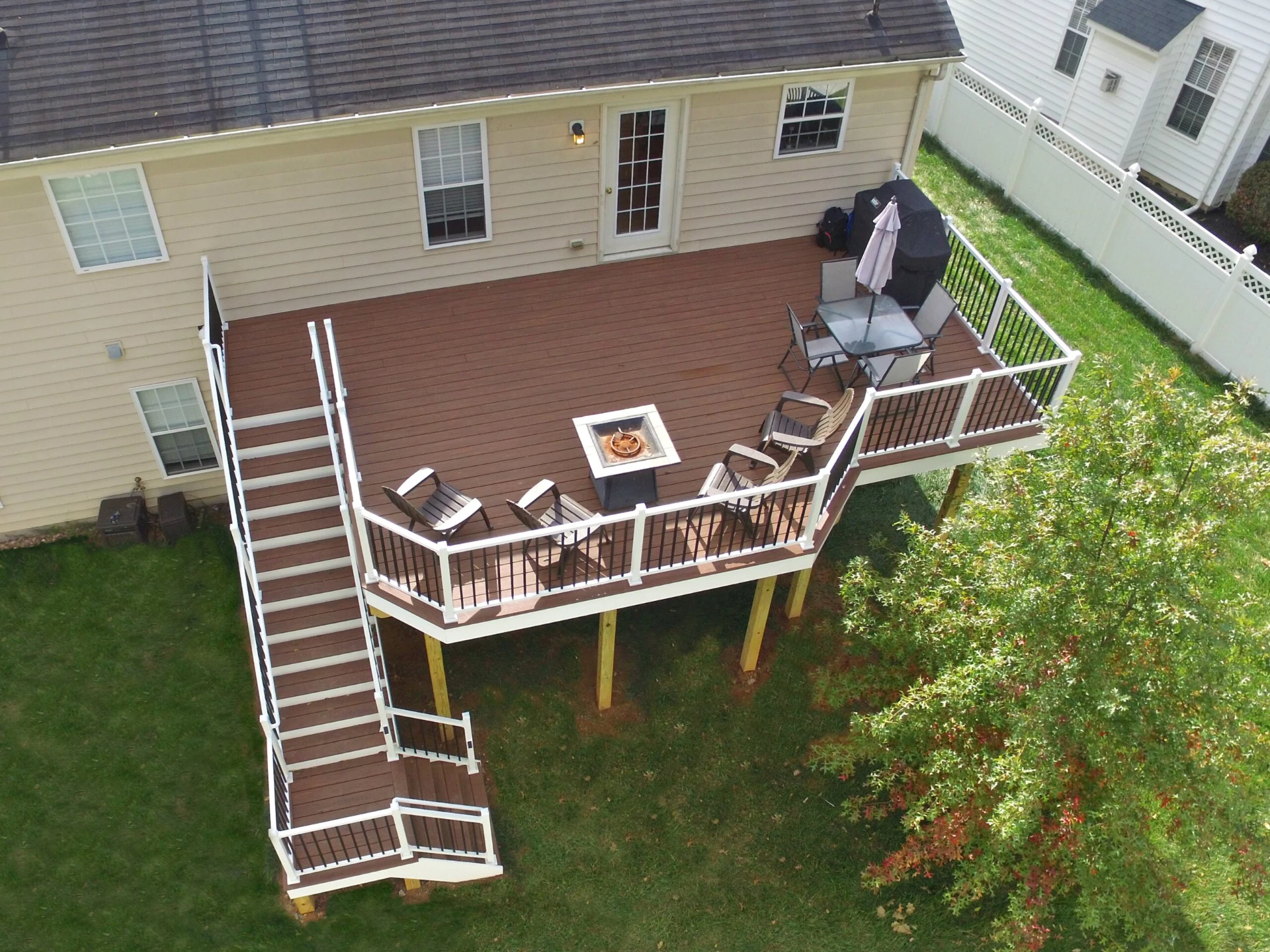 Aerial view of wood deck with outdoor living fire pit and furniture