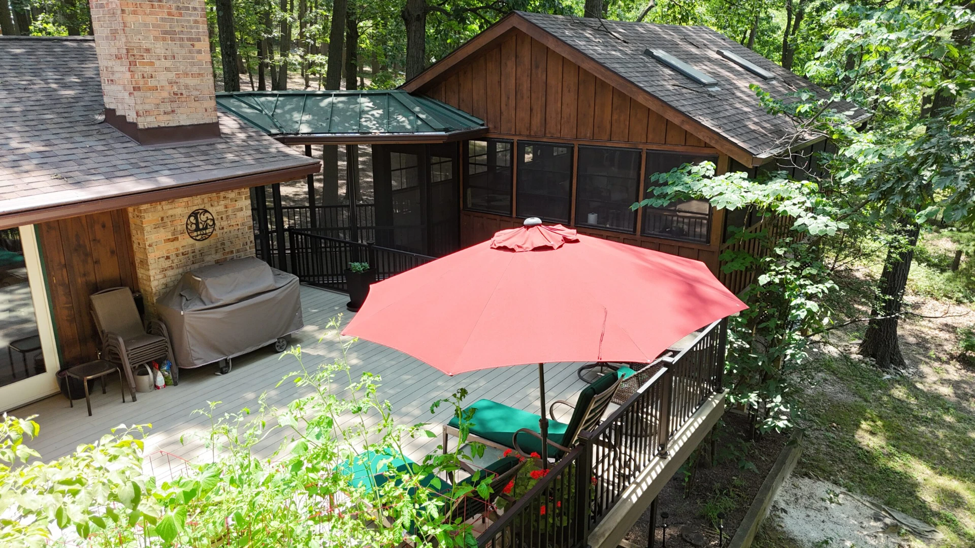 Brown screened porch with outdoor living furniture