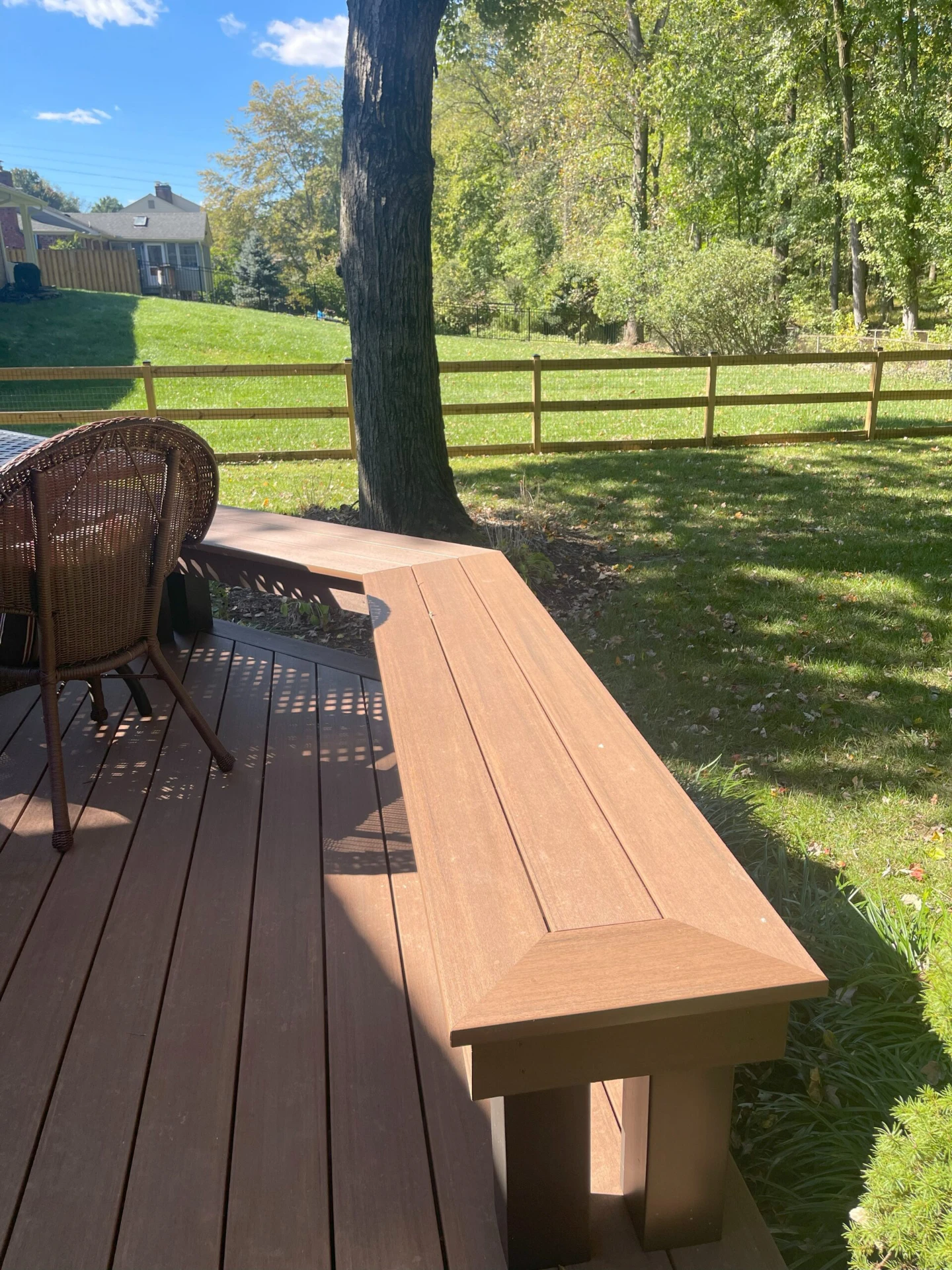 Commercial hard deck with chair and sun kissed lawn view