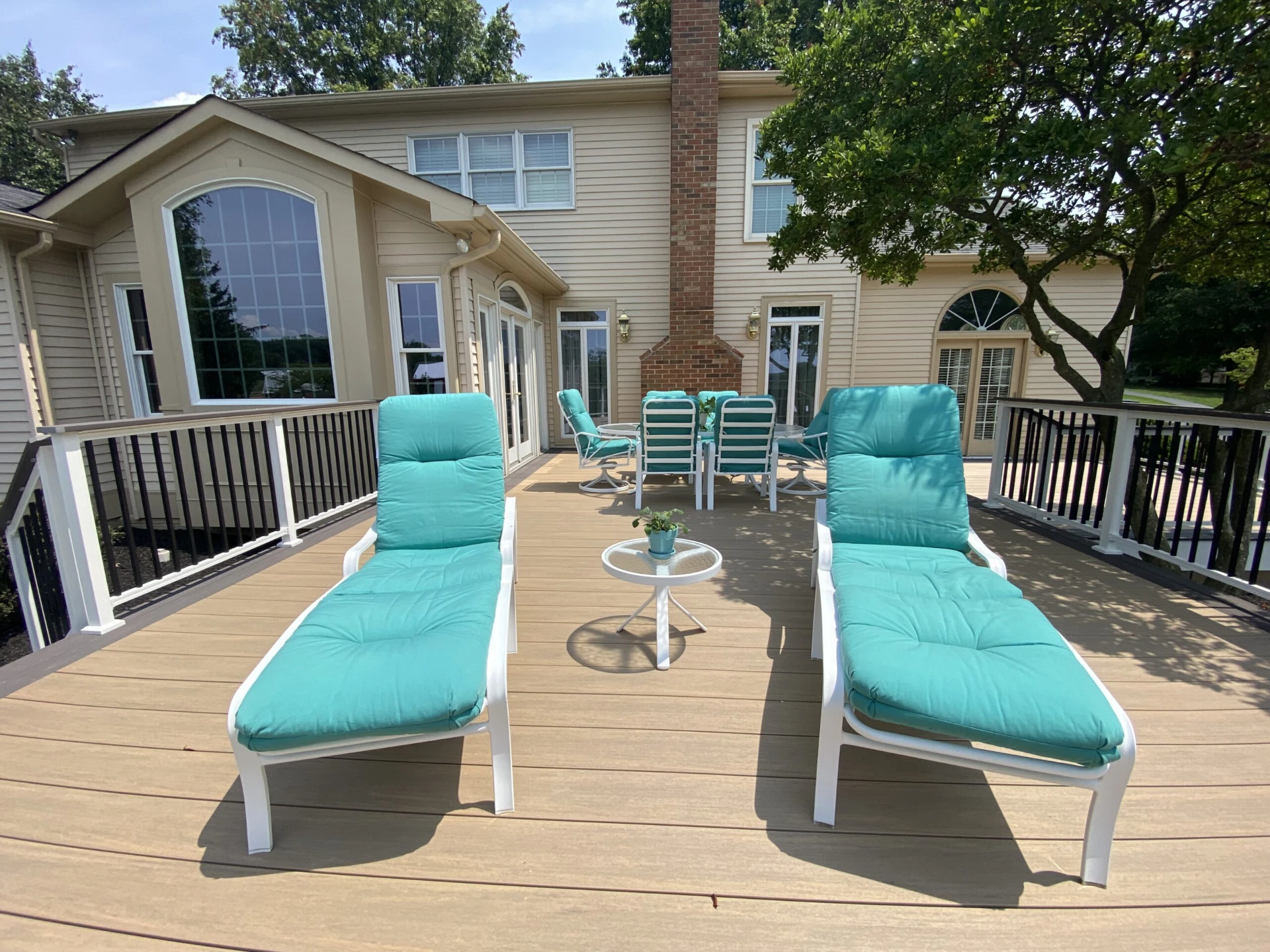 Composite deck with outdoor furniture and tree beside it