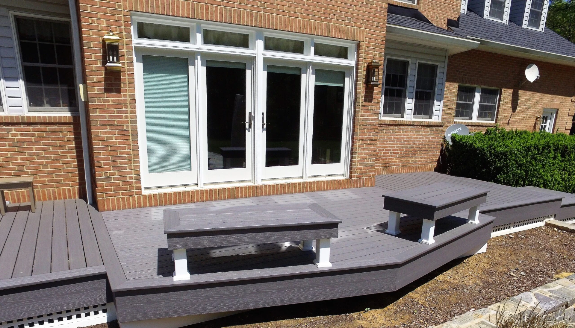 Custom composite deck with chair and a big glass door