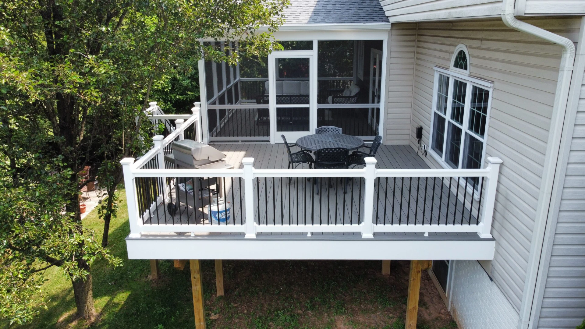 Elevated coastline deck with outdoor living furniture and screened in porches