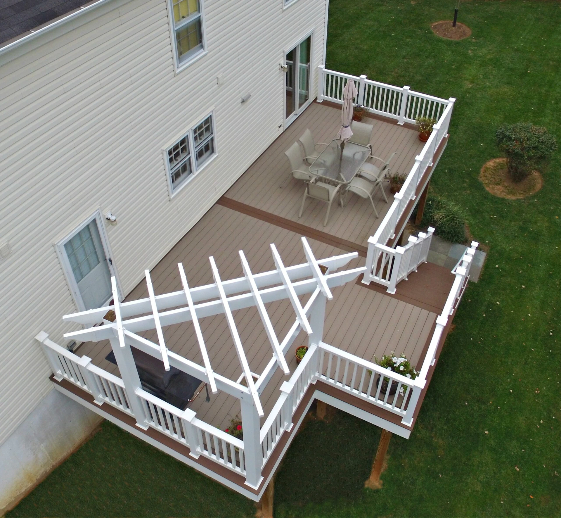 Elevated coastline deck with white pergola and white deck railing
