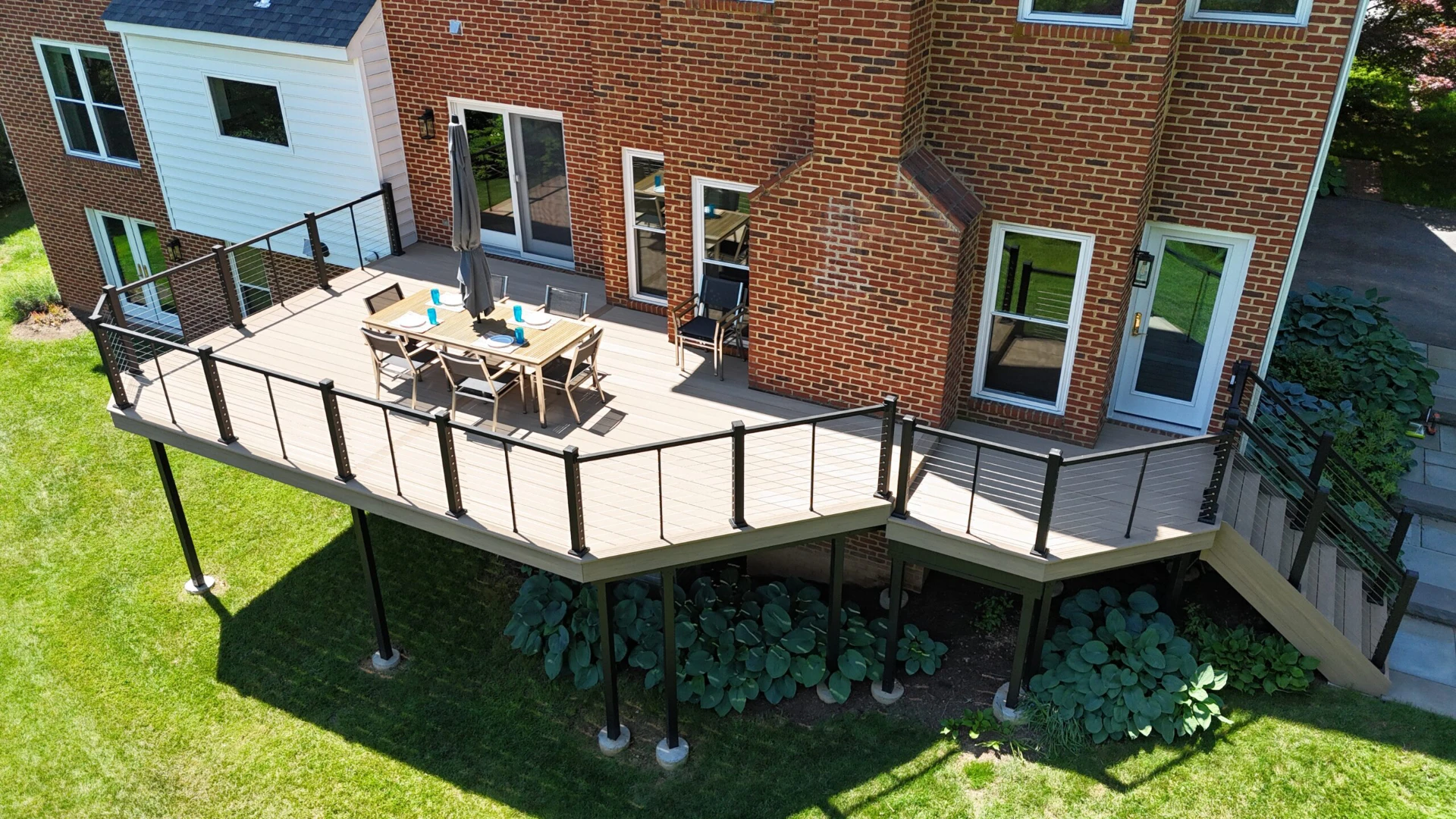 Elevated sun kissed pvc decking with aluminum railing and outdor living furniture