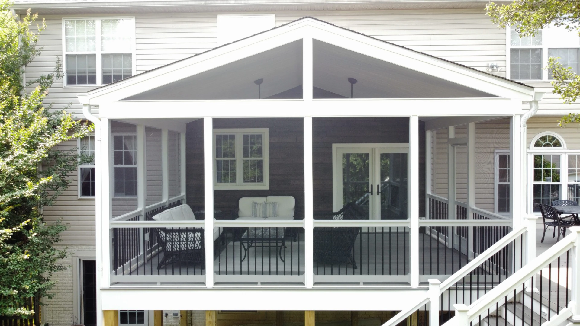 Front view of the elevated gray deck with screened porch