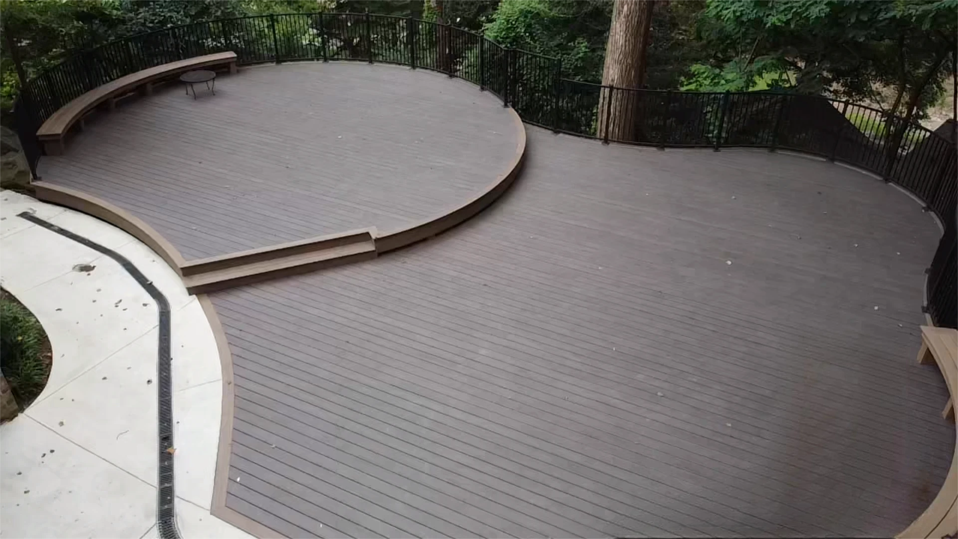 Hard wood deck design and installation with black railing