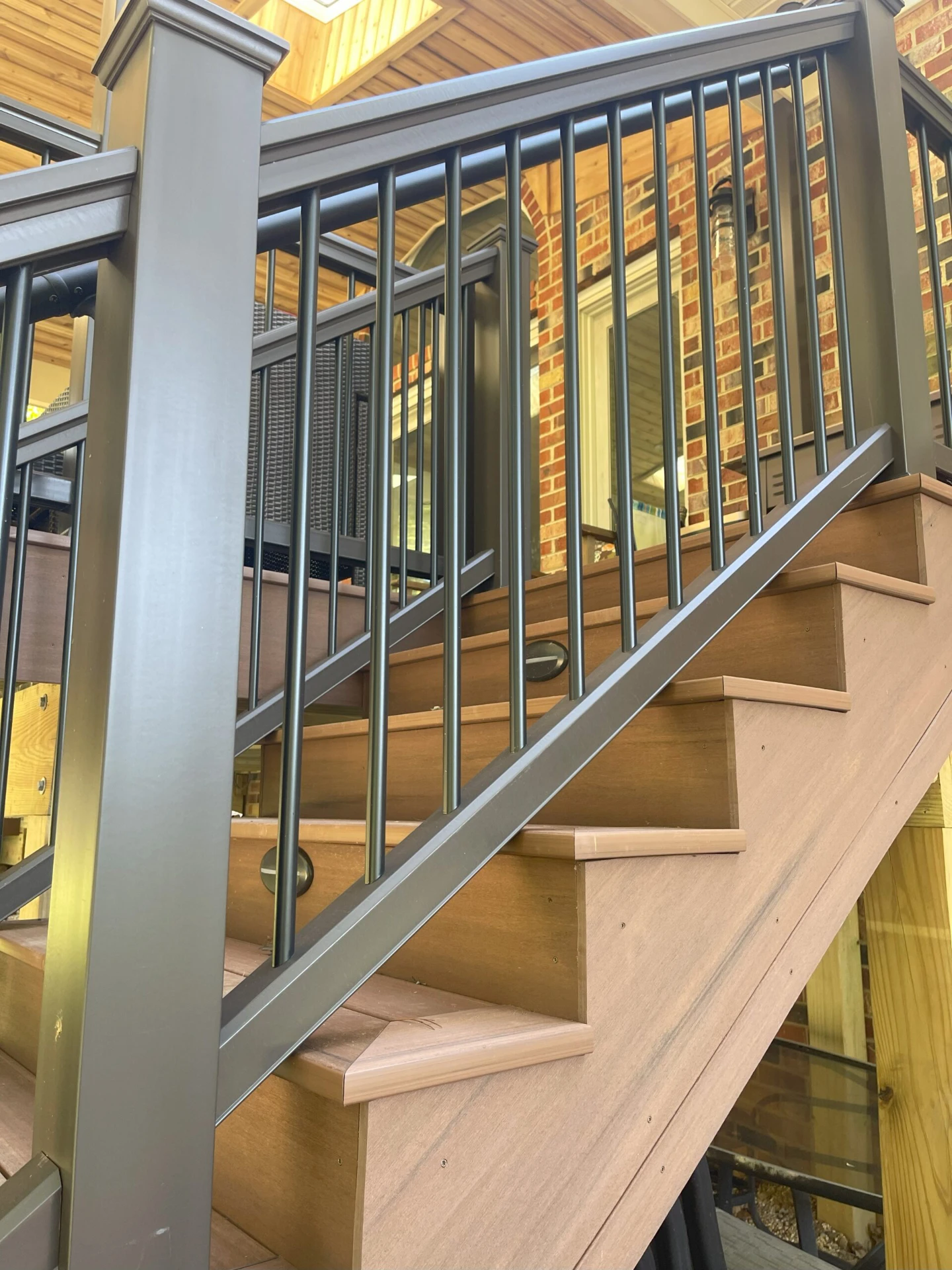 Hard wood stair and deck with lighting and black railing