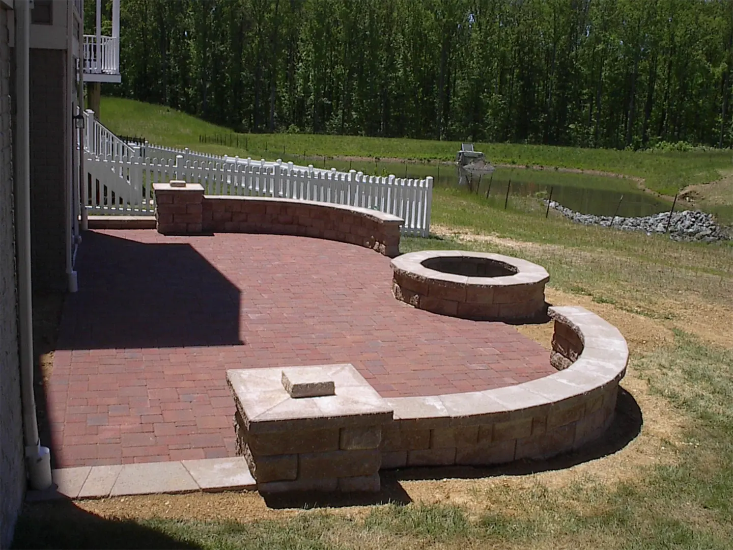 Paver patio with firepit kit and forest view