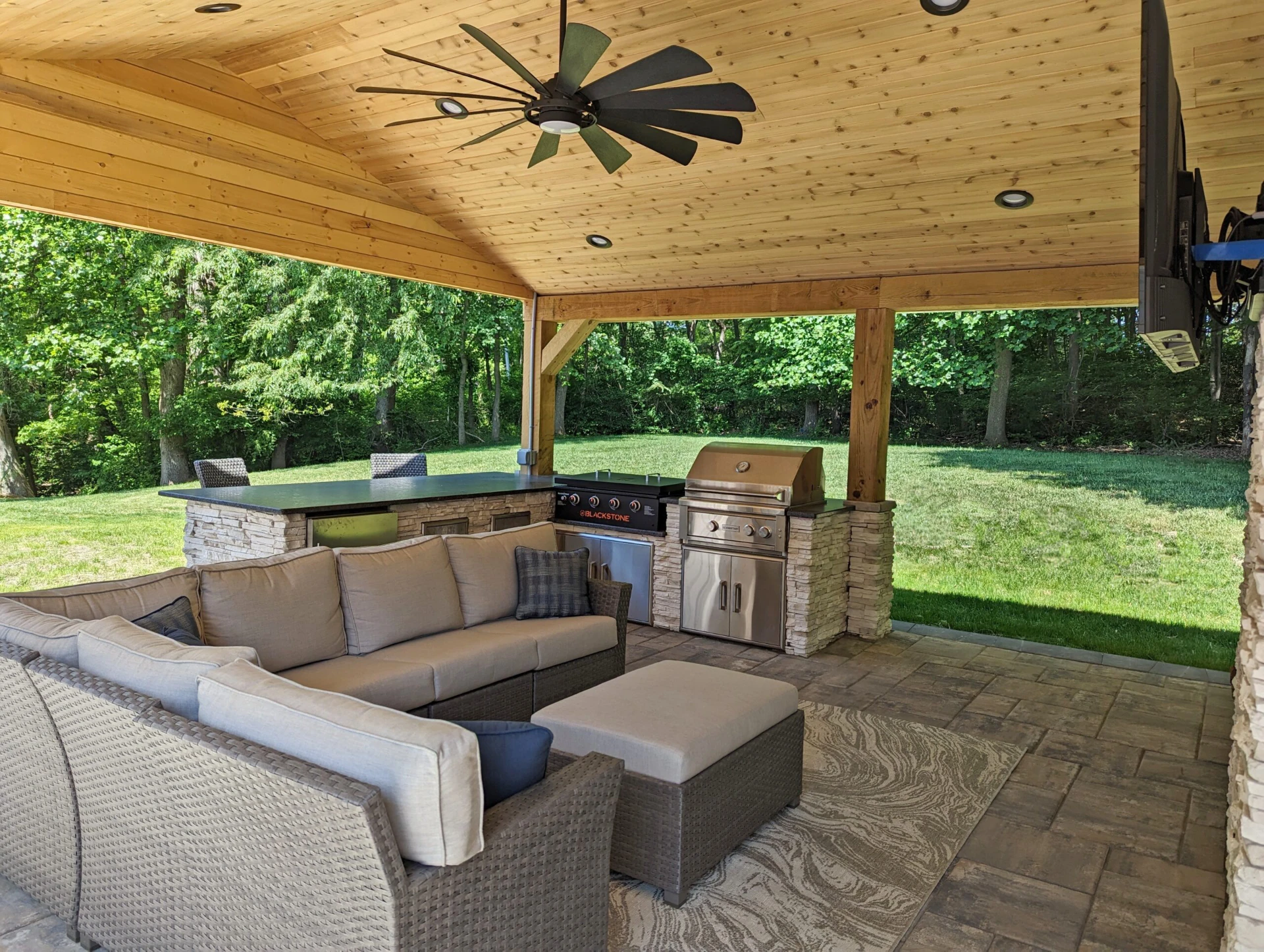 Paver patio with pavilion with recessed lights and kitchen