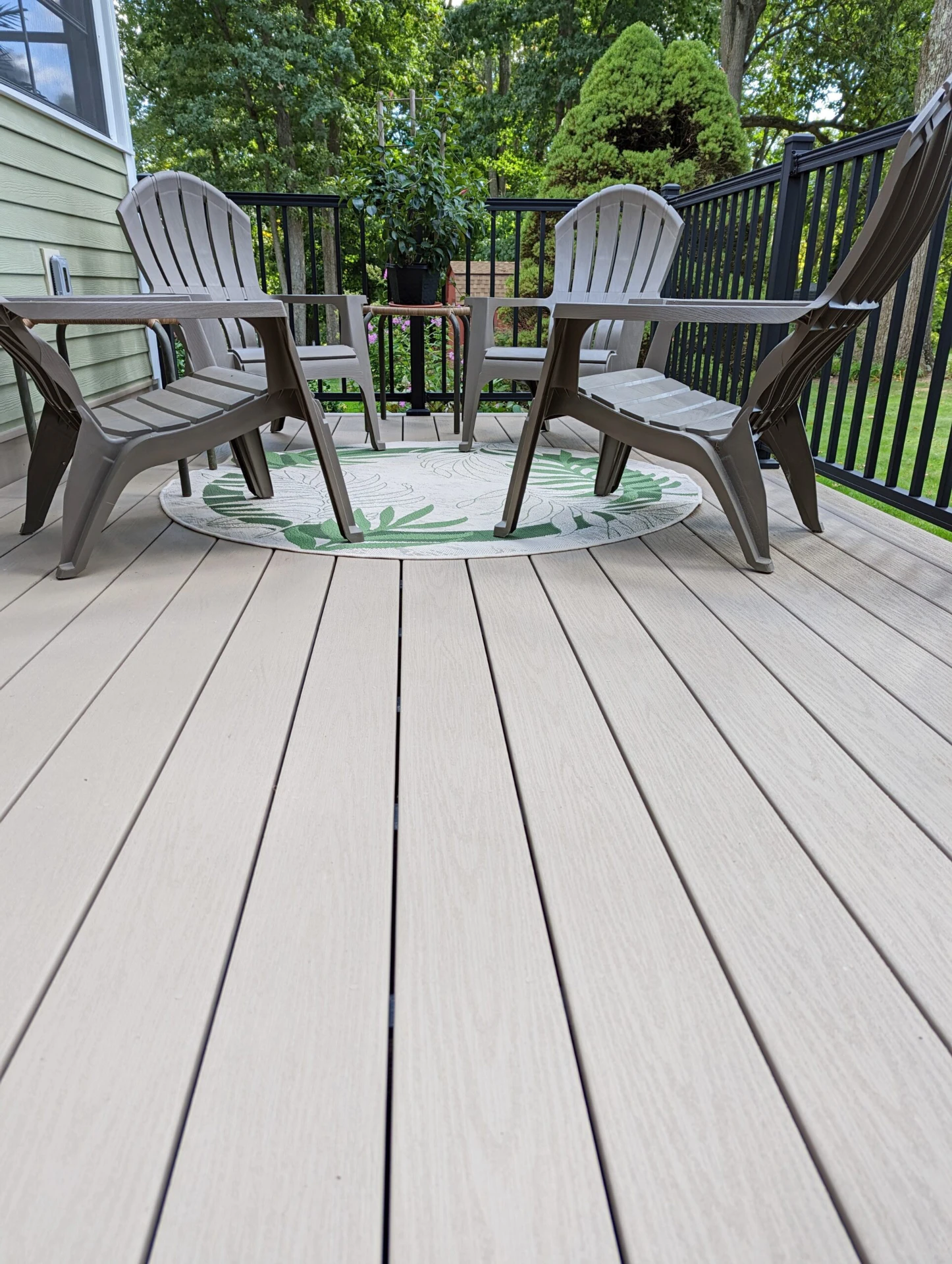 Perspective view of commercial deck with black railing and chair