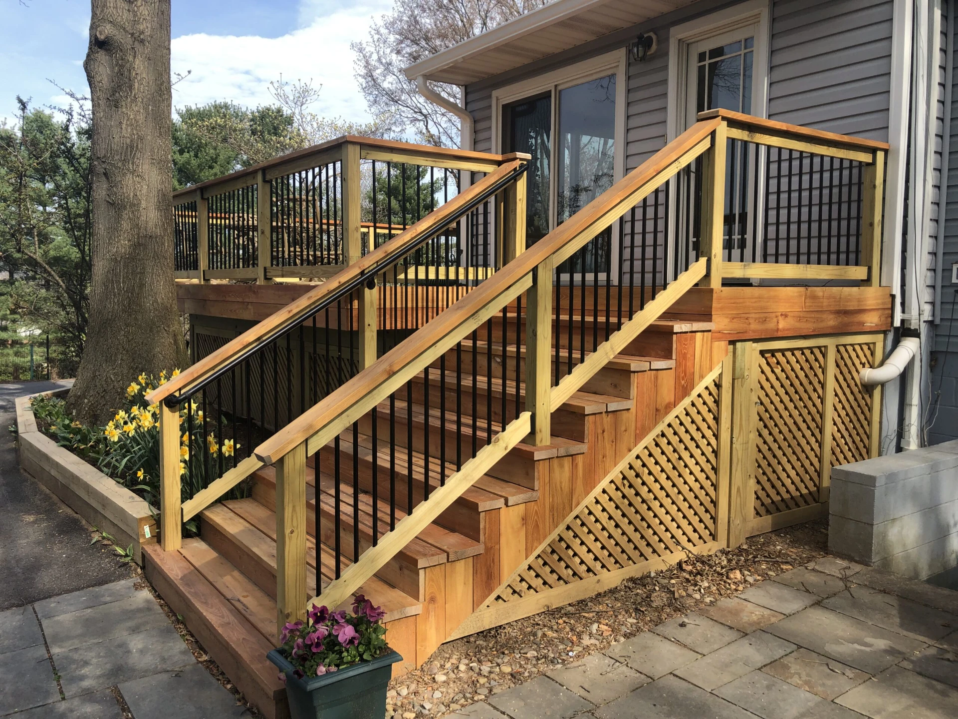 Raised deck with skirting on the gray house