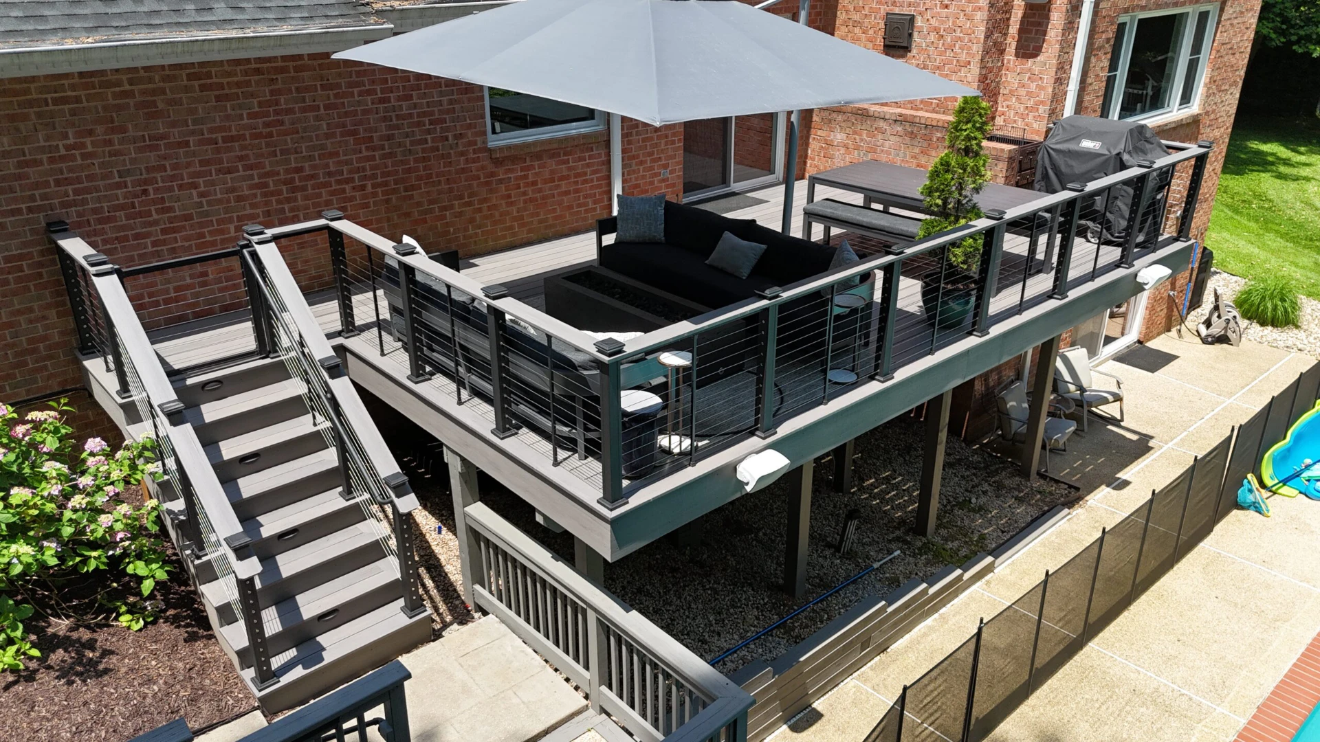 Raised residential deck with aluminum railing and outdoor living furniture