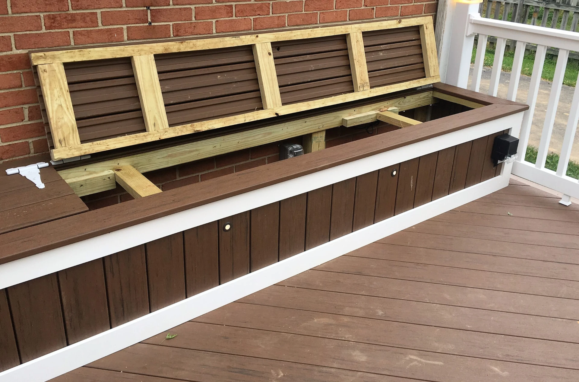 Residential deck with deck box and white railing