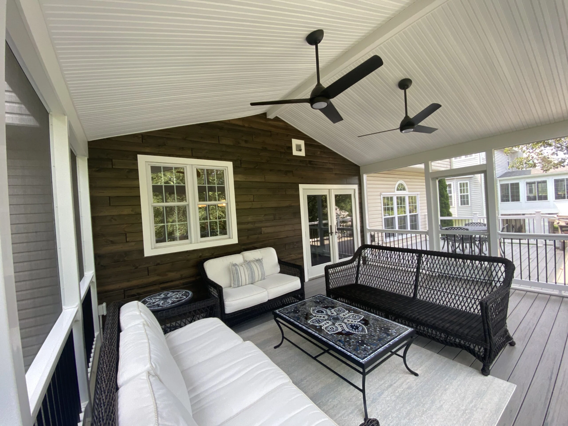 Screened in porch with a fan and coastline decking