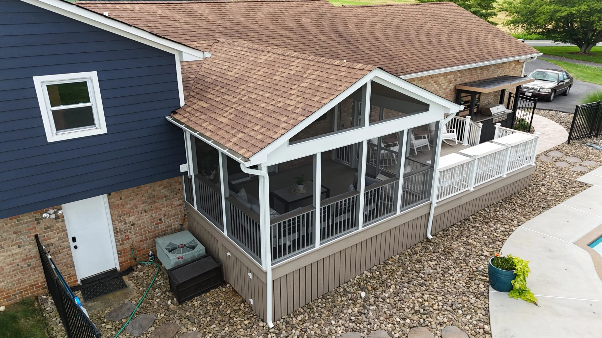 Screened porch installation on the raised residential deck with skirting