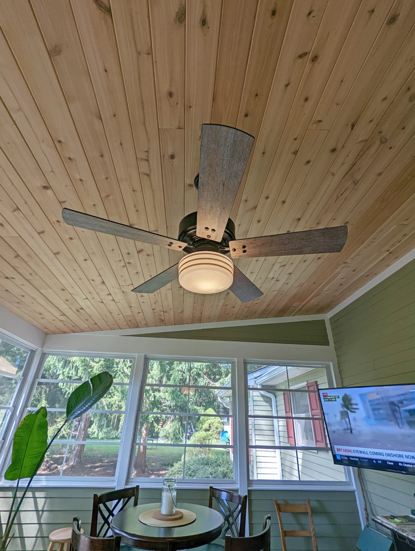 Screened porch with fan on the wooden ceiling