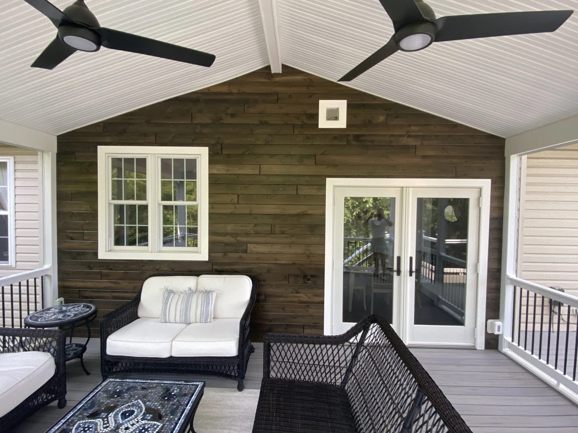 Screened porch with furniture and gray deck