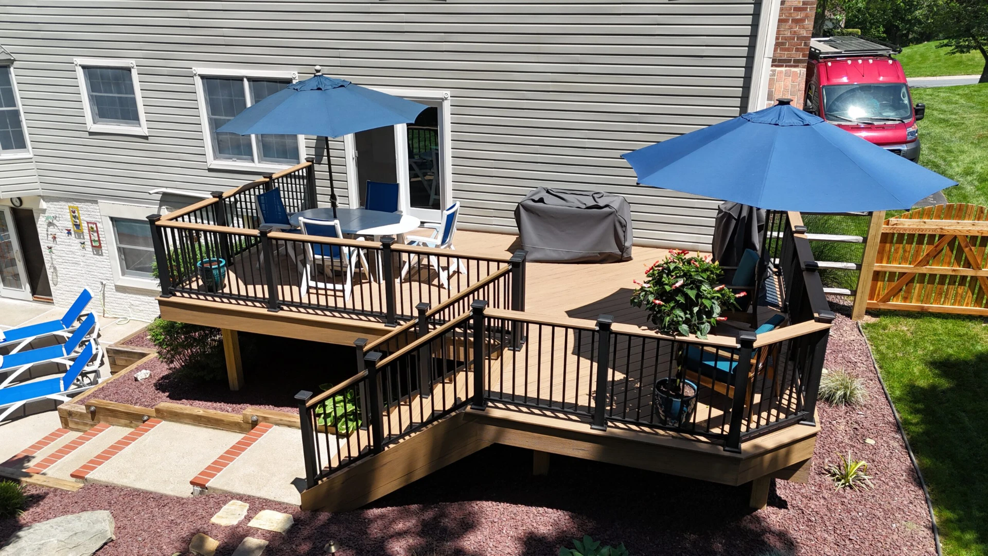 Sun kissed raised deck with black railing and furniture