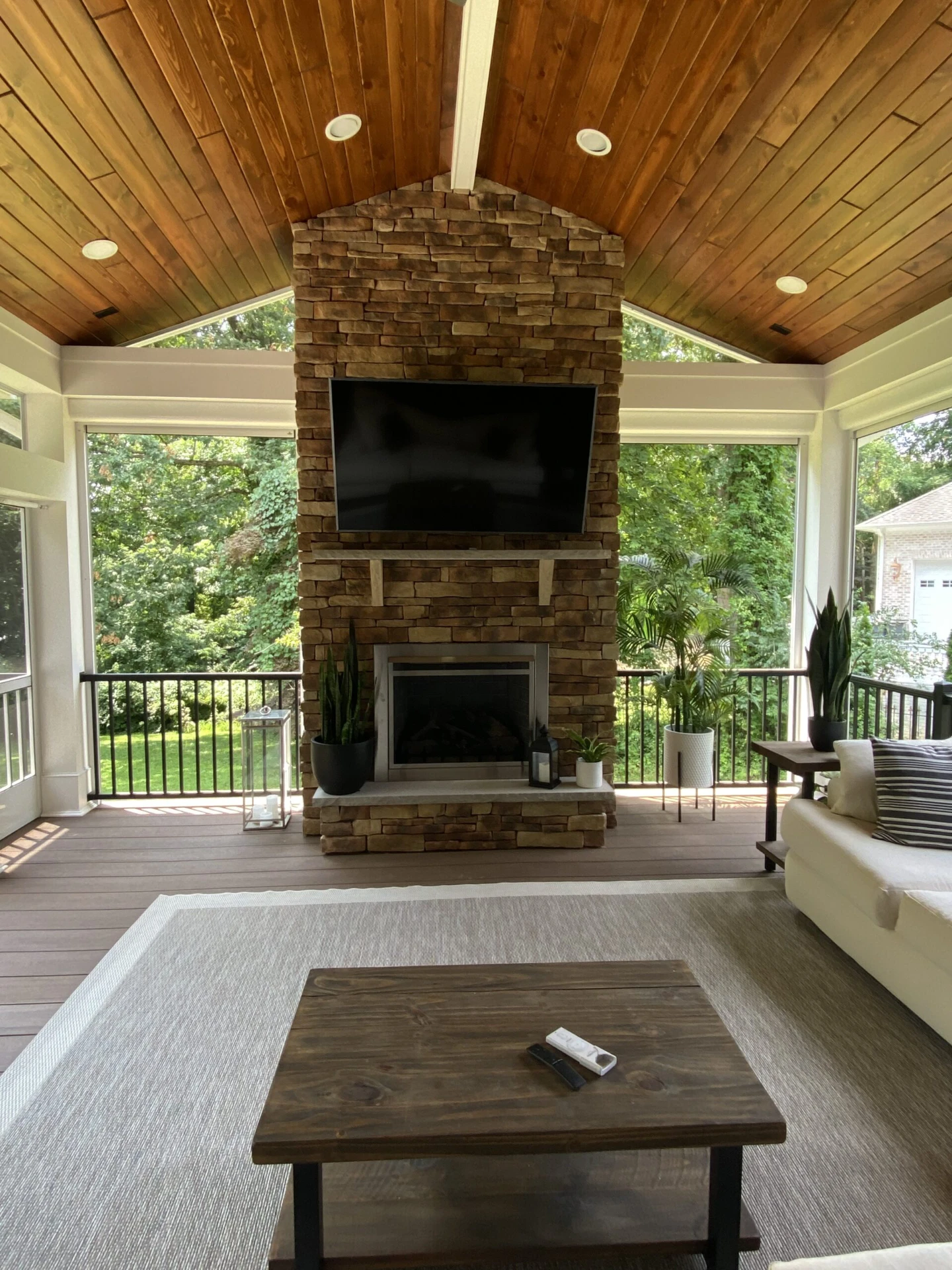 Tv inside the screened in porch with nature scenery outside