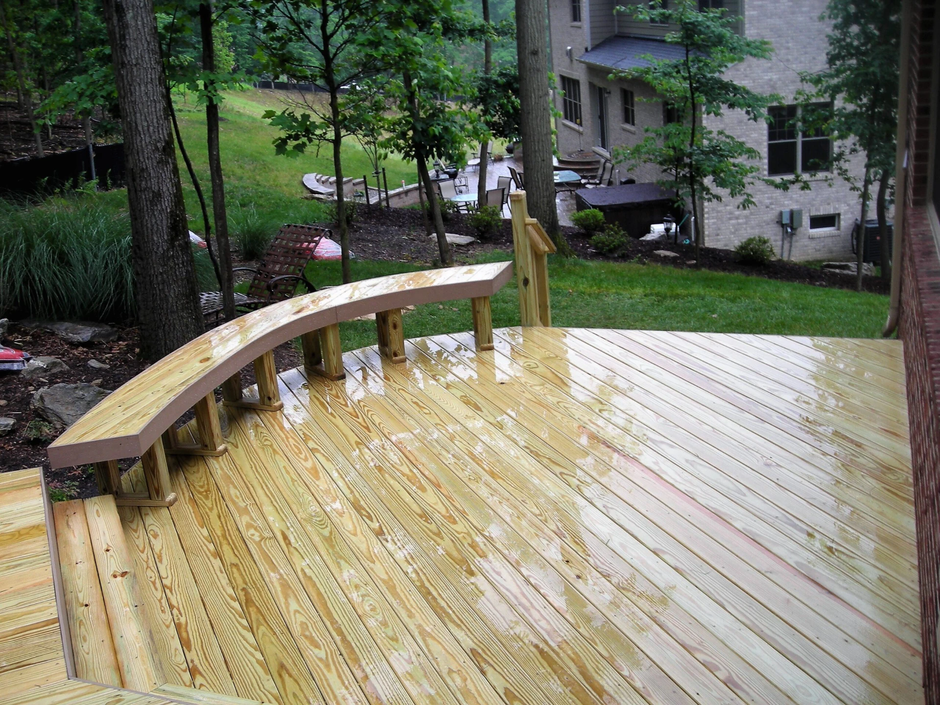Wet wooden deck with chair and nature view