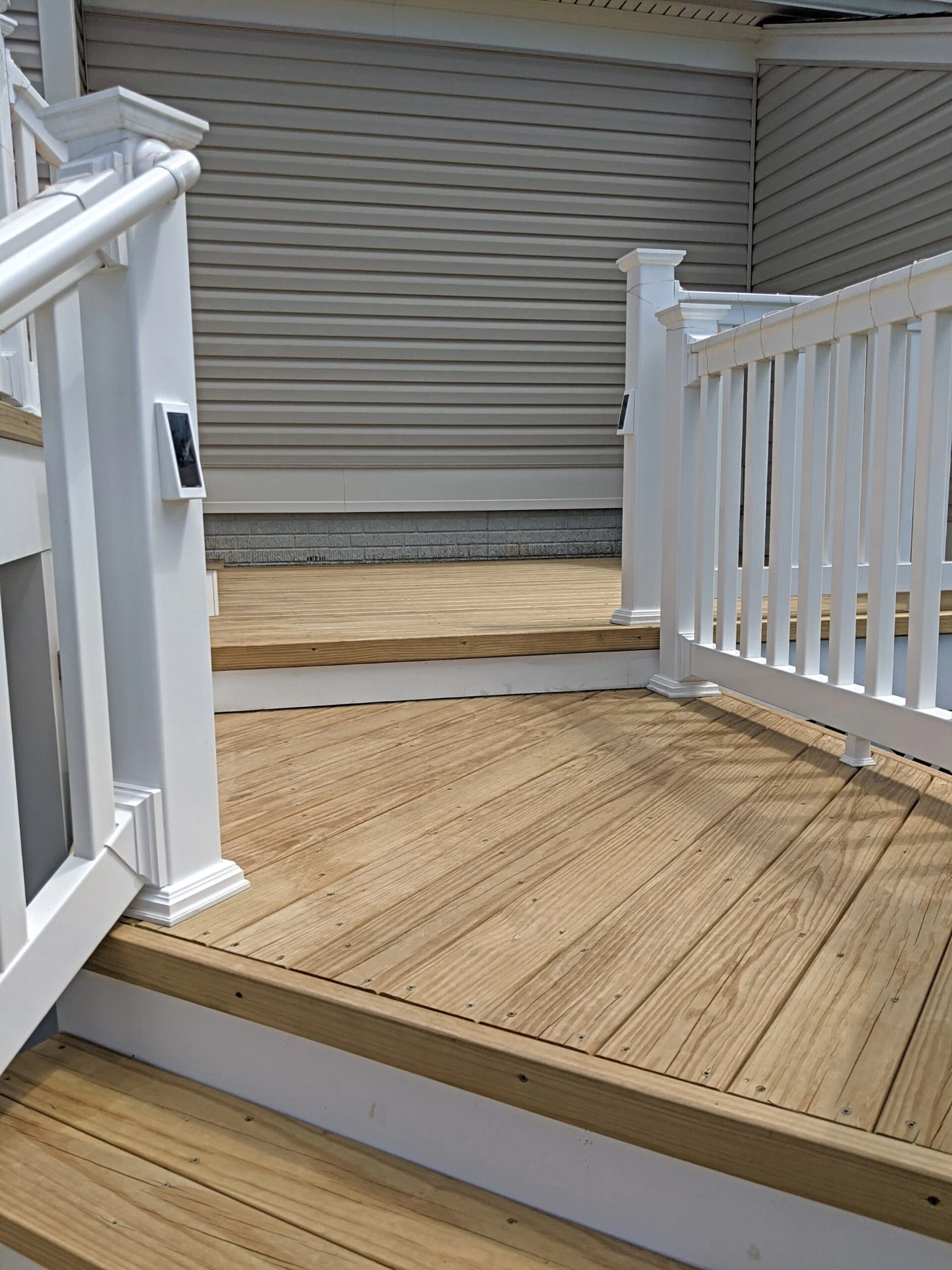 Wood decking frame with white railing
